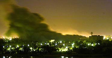 Smoke billows from a building hit during an air raid in Baghdad 